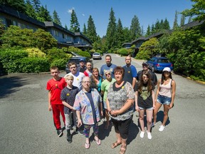Kelly Bond (front-centre) with other residents of Emery Village complex in North Vancouver, BC, June 18, 2018. North Vancouver discussing a rezoning of the property that will displace 61 families renting there. Mosaic Homes owns the property and is seeking to build a 411 unit complex that will include 82 rentals, but only one-bedrooms - not townhomes for families. Residents are upset.