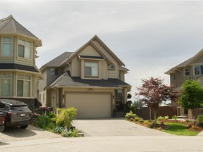 The home of Paul Bennett in Surrey (centre). Bennett was shot dead in his driveway on Saturday.