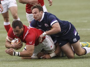 Scotland's Ruaridh Jackson (10) tackles Canada's Luke Campbell (8) during first half action of men's international rugby in Edmonton, Alta., on June 9, 2018.