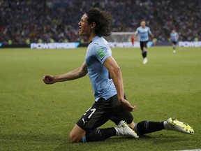Uruguay's Edinson Cavani celebrates after he scored the opening goal during the round of 16 match between Uruguay and Portugal at the 2018 soccer World Cup at the Fisht Stadium in Sochi, Russia, Saturday, June 30, 2018.