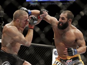 Johny Hendricks, right, exchanges punches with Georges St. Pierre during a UFC 167 mixed martial arts championship welterweight bout in Las Vegas.
