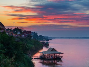 Stunning landscape at Nong Khai, Thailand, on the opposite Mekong river bank. Outstanding colorful cloudscape at dusk.