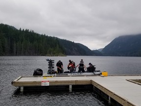 The body of a swimmer who went missing in Buntzen Lake has been recovered. Crews are pictured on the lake where the teen went missing.