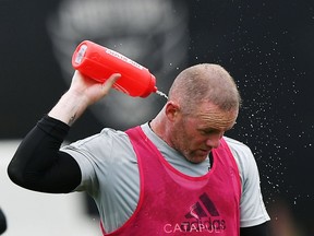 D.C. United player Wayne Rooney, who might play Saturday against the visiting Vancouver Whitecaps, cools off during a training session in Washington, D.C., on July 6, 2018.