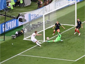 England striker Harry Kane (in white) is not able to put the ball in the net after seemingly having a wide-open chance against Croatia goalkeeper Danijel Subasic (in green) and a pair of Croatia defenders. A goal would have put England up 2-0. Instead they surrendered two (one near the extra time) as Croatia won 2-1 on July 11, 2018 to advance to the FIFA World Cup final on Sunday against France.