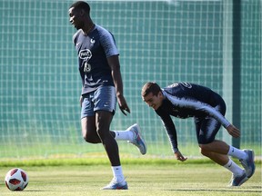 France's midfielder Paul Pogba, left, jokes with forward Antoine Griezmann during Thursday's team training session at Glebovets stadium in Istra, some 70 kilometres west of Moscow. France plays Croatia in Sunday's World Cup.