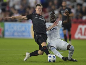 Christopher Durkin (L) of DC United vies for the ball with Kei Kamara (R) during the DC United vs the Vancouver Whitecaps FC match in Washington DC on July 14, 2018.