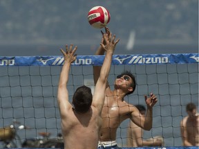 Eddie Fung of Vancouver spikes the the volleyball during a friendly game at Spanish Banks beach park in Vancouver, BC, June 29, 2013. A range of ethnicities can be seen on Vancouver beaches on any given day.