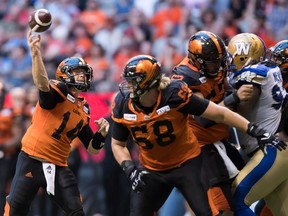 B.C. Lions quarterback Travis Lulay (14) passes against the Winnipeg Blue Bombers during the first half of a CFL football game in Vancouver, on Saturday July 14, 2018.