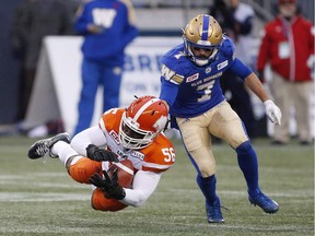 B.C. Lions linebacker Solomon Elimimian goes to ground for the ball against Weston Dressler and the Winnipeg Blue Bombers during an October 2017 CFL game in Winnipeg.