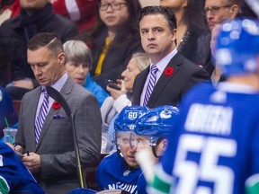 Vancouver Canucks' head coach Travis Green, centre, and assistant coach Newell Brown, left, believe they'll have more talent, depth and success this season.