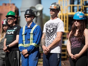 Apprentice ironworkers listen as B.C. Premier John Horgan speaks during an announcement at the Ironworkers Training Facility at the B.C. Institute of Technology, in Burnaby on July 16, 2018.