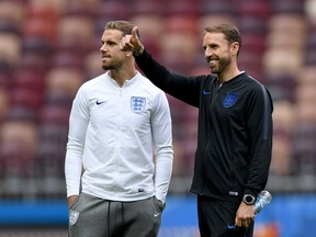 England's midfielder Jordan Henderson (left) and England's coach Gareth Southgate inspect the pitch of the Luzhniki Stadium in Moscow on July 10, 2018, on the eve of their World Cup semifinal football match against Croatia. (AFP/PHOTO)
