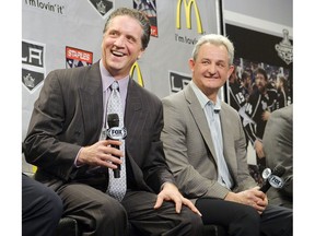 Dean Lombardi, left, with then-head coach Darryl Sutter of the Los Angeles Kings laugh during a news conference in 2013.