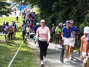People follow Brittany Lincicome, front left, during the first day of competition the PGA Tour Barbasol Championship golf tournament at Keene Trace Golf Club in Nicholasville, Ky., Thursday, July 19, 2018.