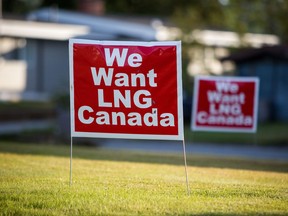 Signs reading "We Want LNG Canada" stand on a lawn in the residential area of Kitimat, British Columbia.