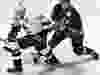Canuck forward Trevor Linden gets a stick between the legs from Annaheim Mighty Duck defenceman Ruslan Salei in 1997.