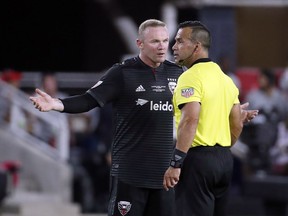 D.C. United forward Wayne Rooney, left, talks with the referee during the second half of an MLS soccer match against the Vancouver Whitecaps at Audi Field, Saturday, July 14, 2018, in Washington.
