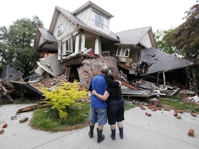 In this Feb. 23, 2011, photo Murray, left, and Kelly James look at their destroyed house in central Christchurch, New Zealand, a day after a deadly earthquake.