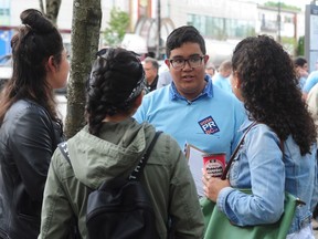 Romeo Tello of Vote PR B.C. canvasses for support of proportional representation at the Broadway SkyTrain Station in Vancouver.