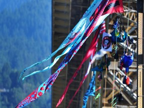 Greenpeace Canada protesters hang from the Ironworkers Memorial Bridge, flying Stephanie Ostler's 40-foot flags.