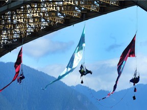 Greenpeace Canada protesters hang from the Ironworkers Memorial Bridge during an aerial blockade of Trans Mountain tar sands oil tanker traffic in Vancouver on Tuesday, July 3, 2018.