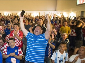 Croatia fans cheer a goal while watching the World Cup on the screens at the Croatian Cultural Centre in Vancouver.