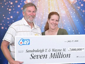 Wayne Martin and Sandee Towers accept their $7-million jackpot won in the June 27 Lotto 6/49 draw. The couple bought the ticket at a 7-Eleven on Granville Avenue in Richmond.