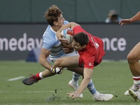 Canada's Matt Mullins, right, is tackled by Argentina's Luciano Gonzalez during the Rugby Sevens World Cup in San Francisco, Friday, July 20, 2018.