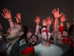 England fans react watching the round of 16 match between Colombia and England on a big screen in a fan zone at the 2018 soccer World Cup in Moscow. England enjoys the most fan support among Canadians, a new poll says.