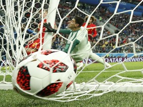 The ball fired by France's Samuel Umtiti hits the back of the net defended by Belgium goalkeeper Thibaut Courtois (in white) during their World Cup semifinal match at the St. Petersburg Stadium in St. Petersburg, Russia, on July 10, 2018. It would be the only goal in France’s 1-0 victory.