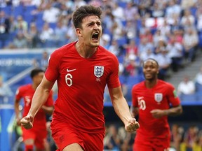 England's Harry Maguire celebrates after scoring his side's opening goal during the quarterfinal match between Sweden and England at the 2018 soccer World Cup in the Samara Arena, in Samara, Russia, Saturday, July 7, 2018.