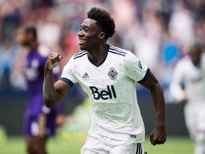 Vancouver Whitecaps' Alphonso Davies celebrates his goal against Orlando City during an MLS game in Vancouver on June 9. The Caps could be without their teenage phenom when they battle the West Coast-rival Seattle Sounders this weekend. The midfielder didn't participate in training Friday.