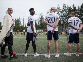 Vancouver Whitecaps head coach Carl Robinson, from left to right, and players Alphonso Davies, Brek Shea and Marcel de Jong stand together before the Hope and Health event for Indigenous youth at the Musqueam First Nation, in Vancouver, on Monday July 9, 2018. Davies made his debut with the Whitecaps as a 15-year-old, and less than three years later, appears to be bound for a European team.