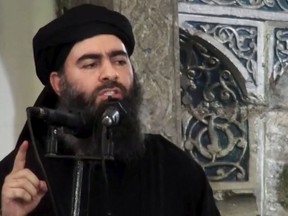 This image made from video posted on a militant website July 5, 2014, purports to show the leader of the Islamic State group, Abu Bakr al-Baghdadi, delivering a sermon at a mosque in Iraq during his first public appearance.