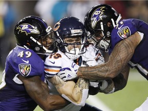 Kamalei Correa #51 and Chris Board #49 of the Baltimore Ravens are called for an illegal hit while tackling Tanner Gentry #19 of the Chicago Bears in the third quarter.