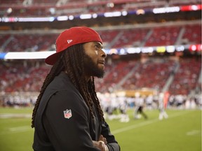 Richard Sherman of the San Francisco 49ers watches a replay on the big screen during his NFL team's pre-season game against the Los Angeles Chargers at Levi's Stadium on Aug. 30 in Santa Clara, Calif. Sherman signed a three-year deal with the 49ers on March 10, one day after being released by the Seattle Seahawks.