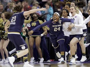 Notre Dame's Arike Ogunbowale and teammate Jessica Shepard celebrate Ogunbowale's game- and championship-winning shot against Mississippi State in the 2018 women's NCAA tournament final.