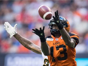 Receiver Kevin Elliott of the B.C. Lionshauls in a pass in front of Edmonton Eskimos' defender Chris Edwards during Thursday's CFL action at B.C. Place Stadium in Vancouver. The Lions won 31-23.