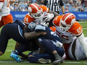 BC Lions running back Jeremiah Johnson (24) pushes through to score a touchdown in second quarter CFL action against the Toronto Argonauts, in Toronto on Saturday, August 18, 2018.
