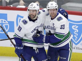 Vancouver Canucks' Henrik Sedin (33) celebrates his goal with Sam Gagner during the first period of an NHL hockey game against the Chicago Blackhawks in Chicago on March 22, 2018. Sam Gagner had a feeling the first question coming his way would be about childhood friend John Tavares. That intuition was spot on. Speaking with reporters before a charity event Wednesday night, the Vancouver Canucks forward discussed last week's abrupt departure of team president Trevor Linden and a host of other topics related to a club that has missed the playoffs the last three seasons thanks to the NHL's worst combined record over that span.