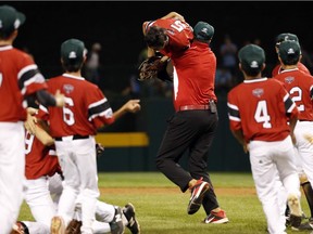 Canada coach Lucky Pawa carries pitcher Nate Colina over his shoulder as they celebrate after the final out of an elimination baseball game against Mexico at the Little League World Series tournament in South Williamsport, Pa., Monday, Aug. 20, 2018. Canada won 6-4.