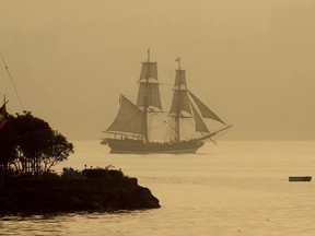 Smoke from Canadian wildfires is even plunging U.S. territory into haze. In this Aug. 14 photo, the tall ship Lady Washington sails off Port Orchard, Wash., about six hours south of Vancouver, B.C.