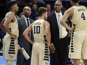 Wake Forest assistant coach Jamill Jones, second from left, with the team and head coach Danny Manning, second from right, during the second half of an NCAA college basketball game in Winston-Salem, N.C. on Nov. 28, 2017.