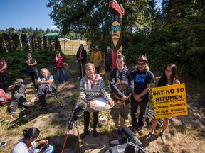 Kwitsel Tatel, left, speaks to the media during a news conference at Camp Cloud near the entrance of the Kinder Morgan Trans Mountain pipeline facility in Burnaby on July 21.