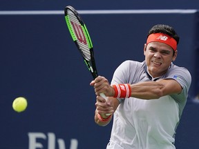 Milos Raonic returns a shot to Frances Tiafoe during the Rogers Cup in Toronto, Wednesday, August 8, 2018. (THE CANADIAN PRESS/Mark Blinch)