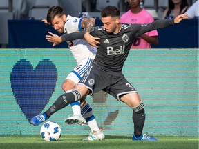 Russell Teibert of the Vancouver Whitecaps, right, battles Montreal Impact's Michael Petrasso for the ball during Canadian Championship semifinal action in Vancouver on Wednesday July 25, 2018.