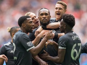 Vancouver Whitecaps' Aaron Maund, from left, Brek Shea, Kendall Waston, centre, Brett Levis and Alphonso Davies celebrate Waston's second goal against the New York Red Bulls during the second half of an Aug. 18 game at B.C. Place.