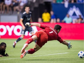 Vancouver Whitecaps' Doneil Henry, left, watches as goalkeeper Stefan Marinovic fails to stop the ball leading to an own goal after Henry got his head on it. The second leg of the final will be played in Toronto on Wednesday, Aug. 15.