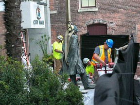 A harness is strapped to the statue of Canada's first prime minister, Sir John A. Macdonald, after Victoria city council voted to remove it from outside city hall as an act of reconciliation with First Nations. Crowds gathered on Saturday, Aug. 11, 2018, either to protest the removal or to cheer the decision.